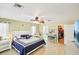 Neutral bedroom features tile floors, a ceiling fan, a walk-in closet, and a nice sitting area at 6418 Austrian Blvd, Punta Gorda, FL 33982