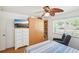Cozy bedroom with a window, dresser, TV, and ceiling fan at 6418 Austrian Blvd, Punta Gorda, FL 33982