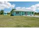 Charming home with a metal roof and welcoming front porch, set on a large, well-manicured lawn at 6418 Austrian Blvd, Punta Gorda, FL 33982