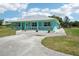 Well-maintained home featuring a metal roof and a concrete driveway, complemented by a lush green lawn at 6418 Austrian Blvd, Punta Gorda, FL 33982