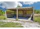 Well-maintained horse shelter with concrete floor and sturdy wood construction provides protection from the elements at 6418 Austrian Blvd, Punta Gorda, FL 33982