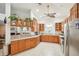 Spacious kitchen with breakfast bar overlooking living area and stainless steel refrigerator at 6418 Austrian Blvd, Punta Gorda, FL 33982