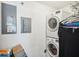 Laundry room features a stacked washer and dryer with a white wall at 6418 Austrian Blvd, Punta Gorda, FL 33982