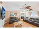 Comfortable living room with fireplace, ceiling fan, and updated flooring at 6418 Austrian Blvd, Punta Gorda, FL 33982