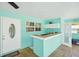 Outdoor kitchen with a tile counter and sink, and an exterior door at 6418 Austrian Blvd, Punta Gorda, FL 33982