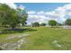 Picturesque pasture view showcasing the vastness of the property with scattered trees and a distant home at 6418 Austrian Blvd, Punta Gorda, FL 33982