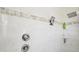 Shower features tiled walls with decorative tile border at 6418 Austrian Blvd, Punta Gorda, FL 33982