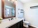 Updated bathroom with modern vanity, wood-framed mirror, and glass shower at 6826 Rosemary Dr, Tampa, FL 33625