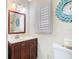 Bathroom with updated vanity and decorative mirror at 7303 N Branch Ave, Tampa, FL 33604
