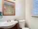 Bathroom featuring a vanity, mirror, toilet, and tiled shower at 7303 N Branch Ave, Tampa, FL 33604