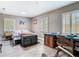 Sunlit bedroom with desk area, stylish shutters, and decorative antique-style trunk at 7303 N Branch Ave, Tampa, FL 33604