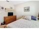 Bedroom featuring a wood dresser and furnishings, and framed wall art at 7303 N Branch Ave, Tampa, FL 33604