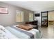 Neutral bedroom with accent wall, mounted TV, sliding barn door, and lots of sunlight at 7303 N Branch Ave, Tampa, FL 33604