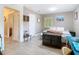 Bright bedroom with modern lighting, wood-look floors, and a large decorative trunk at 7303 N Branch Ave, Tampa, FL 33604