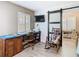 Bright bedroom workspace featuring barn door and a comfortable rocking chair at 7303 N Branch Ave, Tampa, FL 33604