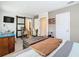 Spacious bedroom featuring wood-look floors, barn door, and unique furniture at 7303 N Branch Ave, Tampa, FL 33604
