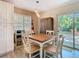 Charming dining area with bright natural light, seating for four, and easy access to the backyard at 7303 N Branch Ave, Tampa, FL 33604
