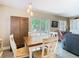 Bright dining area with seating for four, offering easy access to outdoor patio and natural light at 7303 N Branch Ave, Tampa, FL 33604