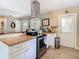 Kitchen with stainless steel range and hood, butcher block counters and white cabinets at 7303 N Branch Ave, Tampa, FL 33604