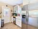 Bright kitchen featuring stainless steel appliances, white cabinetry, and a farmhouse sink at 7303 N Branch Ave, Tampa, FL 33604