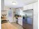 Updated kitchen with stainless steel appliances, white cabinetry, and a farmhouse sink at 7303 N Branch Ave, Tampa, FL 33604