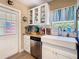 Bright kitchen featuring a farmhouse sink, stainless steel dishwasher, and butcher block countertop at 7303 N Branch Ave, Tampa, FL 33604