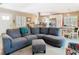 Inviting living room with a spacious gray sectional sofa and ample natural light from the windows at 7303 N Branch Ave, Tampa, FL 33604
