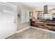 Stylish living area highlighting a reclaimed wood kitchen counter and front entry with natural light at 7303 N Branch Ave, Tampa, FL 33604