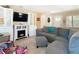 Comfortable living room showcasing a gray sectional sofa, fireplace, and built-in shelving at 7303 N Branch Ave, Tampa, FL 33604