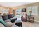 Cozy living room featuring a comfortable gray sectional couch and eye-catching colorful accent chair at 7303 N Branch Ave, Tampa, FL 33604