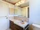 The bathroom features a vanity with marble countertops, mirror and a toilet at 7330 Cherry Laurel Dr, Port Richey, FL 34668