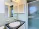 Bathroom showcasing sink, walk-in shower, and green tile at 7330 Cherry Laurel Dr, Port Richey, FL 34668