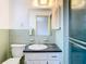 Bathroom with retro sink, light green tile, and walk-in shower at 7330 Cherry Laurel Dr, Port Richey, FL 34668