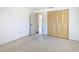 Bright bedroom featuring a closet with folding doors and neutral carpeting at 7330 Cherry Laurel Dr, Port Richey, FL 34668