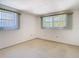 A sunlit bedroom featuring two windows, bright walls and neutral carpet at 7330 Cherry Laurel Dr, Port Richey, FL 34668