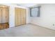 Bright bedroom featuring a window, carpeted floors and a closet with folding doors at 7330 Cherry Laurel Dr, Port Richey, FL 34668