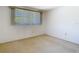 Bright bedroom featuring a window and neutral carpet at 7330 Cherry Laurel Dr, Port Richey, FL 34668