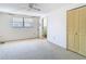 Bedroom includes large closet, ceiling fan, and bathroom access at 7330 Cherry Laurel Dr, Port Richey, FL 34668