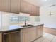 Bright kitchen with stainless dishwasher, double sink and view into the main living space at 7330 Cherry Laurel Dr, Port Richey, FL 34668
