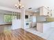 Living room with wood flooring and direct view of kitchen appliances at 7330 Cherry Laurel Dr, Port Richey, FL 34668