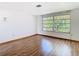 Bright living room featuring neutral walls and sleek hardwood floors at 7330 Cherry Laurel Dr, Port Richey, FL 34668