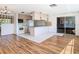 Living room with wood floors and open kitchen area at 7330 Cherry Laurel Dr, Port Richey, FL 34668