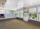 The sunroom features large windows providing natural light at 7330 Cherry Laurel Dr, Port Richey, FL 34668