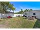 Backyard with fire pit, lawn, patio furniture and privacy fence at 7401 35Th N Ave, St Petersburg, FL 33710