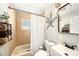 Bathroom with neutral tile, updated vanity, and decorative touches at 7401 35Th N Ave, St Petersburg, FL 33710