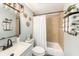 This bathroom has a shower-tub combo with neutral tile and a modern vanity with a black faucet at 7401 35Th N Ave, St Petersburg, FL 33710