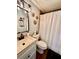 Charming bathroom with a decorative mirror, neutral walls, and a shower curtain adding a touch of comfort at 7401 35Th N Ave, St Petersburg, FL 33710