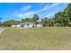 Spacious front yard with lush green grass, offering plenty of room for outdoor activities and potential landscaping opportunities at 7401 35Th N Ave, St Petersburg, FL 33710