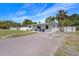 Well-maintained front yard with lush green grass, an inviting driveway, and ample space for parking and outdoor enjoyment at 7401 35Th N Ave, St Petersburg, FL 33710