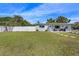 Well-maintained front yard featuring lush green grass, a charming white fence, and a cozy seating area on the porch at 7401 35Th N Ave, St Petersburg, FL 33710